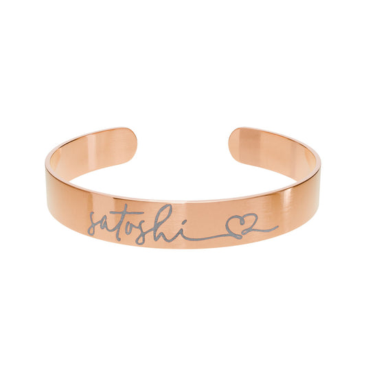 Rose gold bracelet with 'satoshi' and a heart symbol on a white background