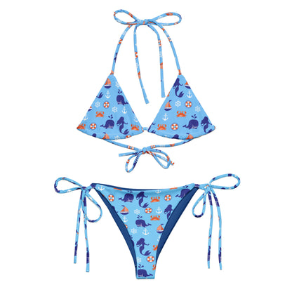 Blue bikini set with satoshi ocean-themed pattern on a white background
