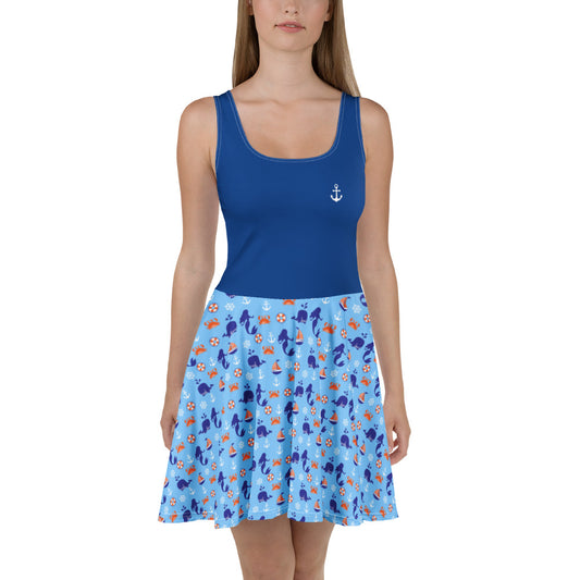 Woman wearing a blue dress with a nautical patterned skirt and tank top on a white background