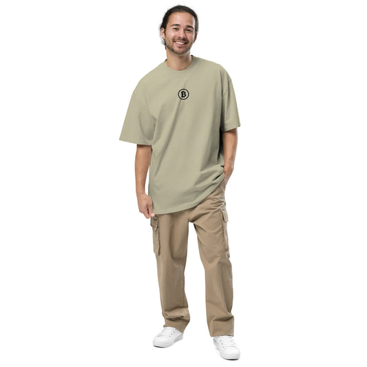 Man wearing a beige t-shirt with a Bitcoin logo and beige pants on a white background