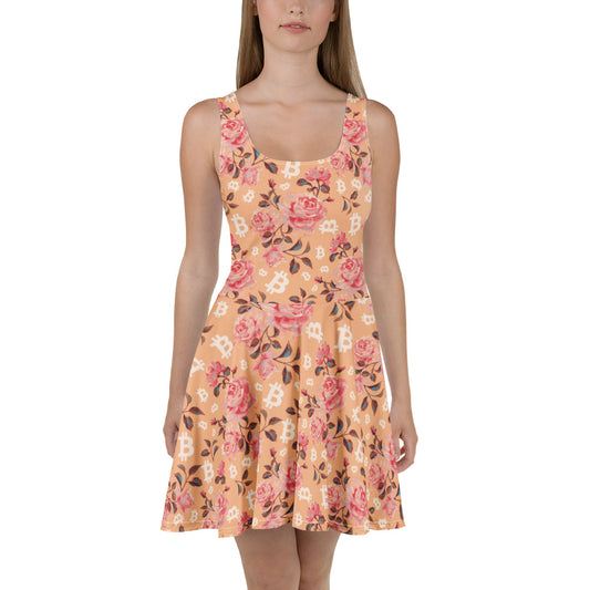 Woman wearing a peach floral dress with bitcoin symbols on a white background