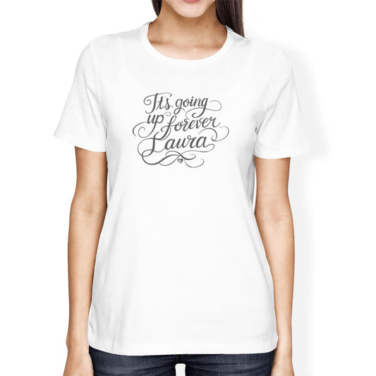 White t-shirt with text 'It's going up forever Laura' worn by a person on a white background